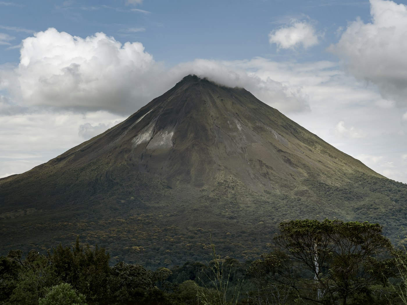 Arenal Volcano rising above a green tropical forest
