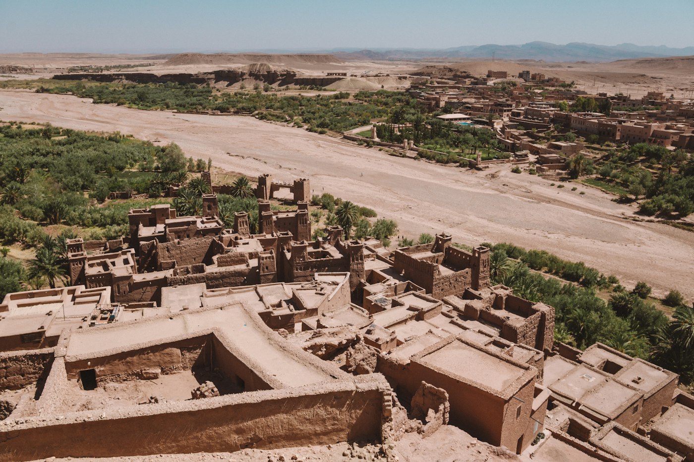 Earthen buildings of Aït Benhaddou beneath hills in Morocco